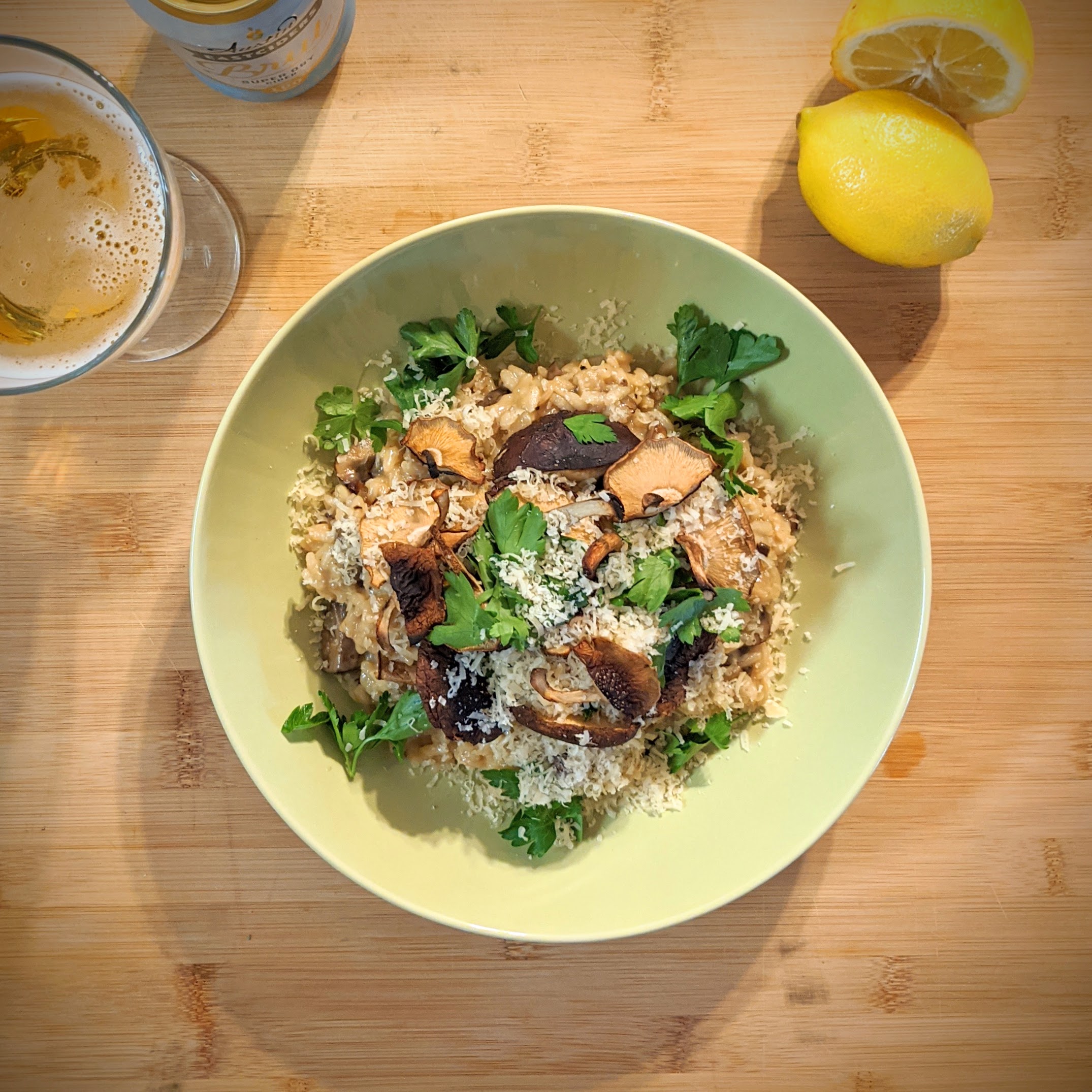A shaved brussels sprout and carrot salad on a plate, on a bright wood counter